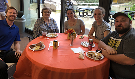 A group of people at The Hampton Plaza enjoying an End of Summer BBQ party.