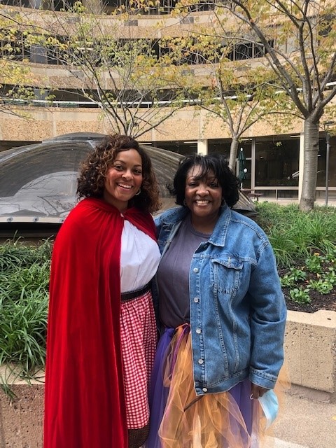 Yvonne F. on the 15th Floor shines in her red riding hood costume alongside a little red rooster.