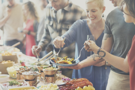 A group of people enjoying breakfast at a party.