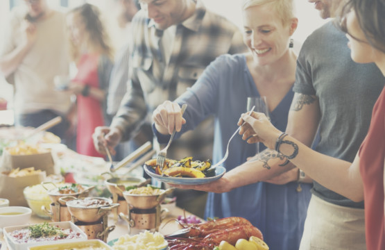 A group of people enjoying breakfast at a party.