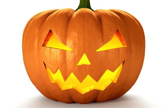 A carved pumpkin with glowing eyes participating in a pumpkin carving contest.