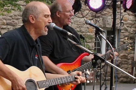 Two musicians performing live music in the Hampton Plaza Courtyard.