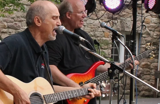 Two musicians performing live music in the Hampton Plaza Courtyard.