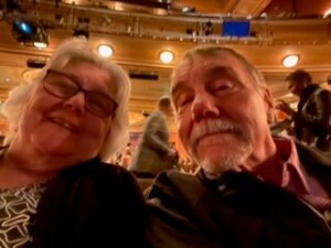 A man and woman taking a selfie in an auditorium during Resident Spotlight on Jane C.