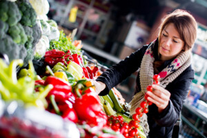 A woman selecting vegetables at a Towson market during fall 2023.